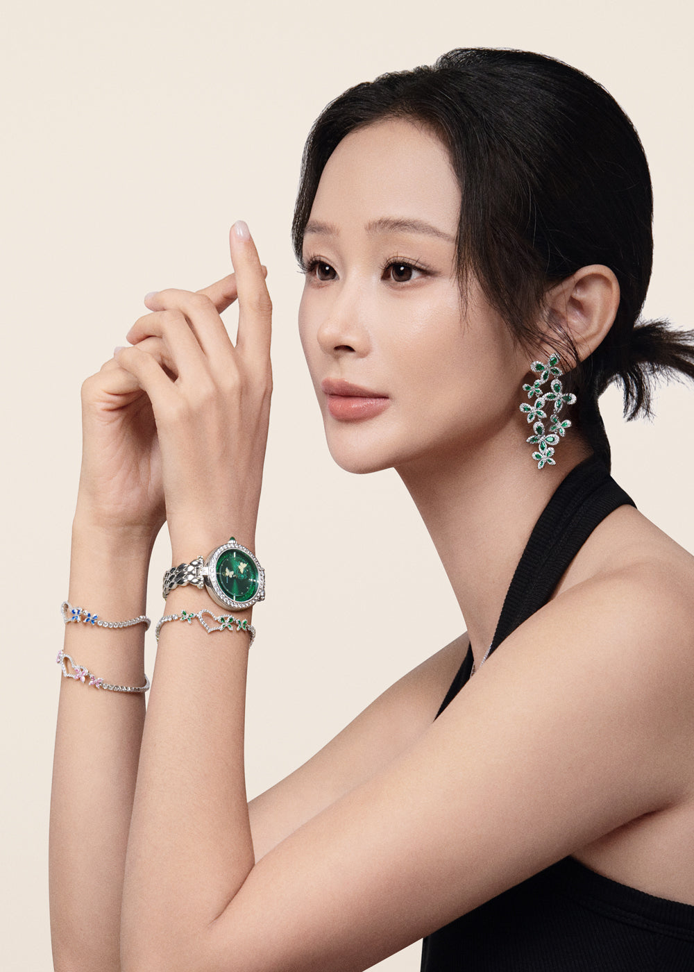 Model wearing a green watch, floral earrings and bracelets by BLACK BY BLUE BRAVE