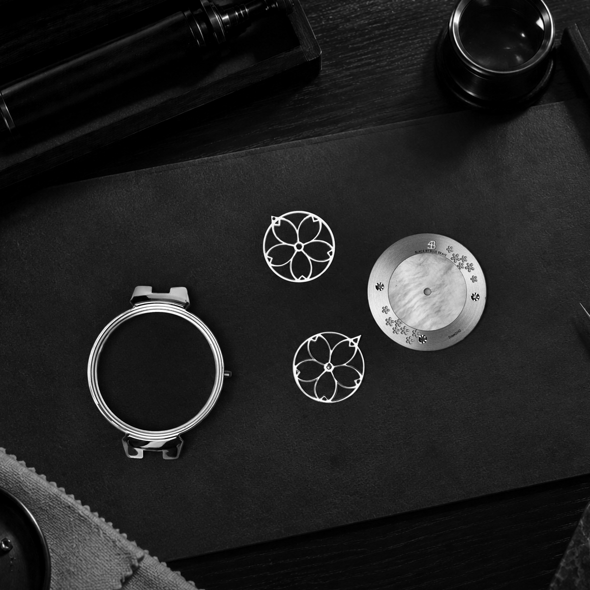 black by blue brave watch craftsmanship image showing the case, dial and blossom-shaped components
